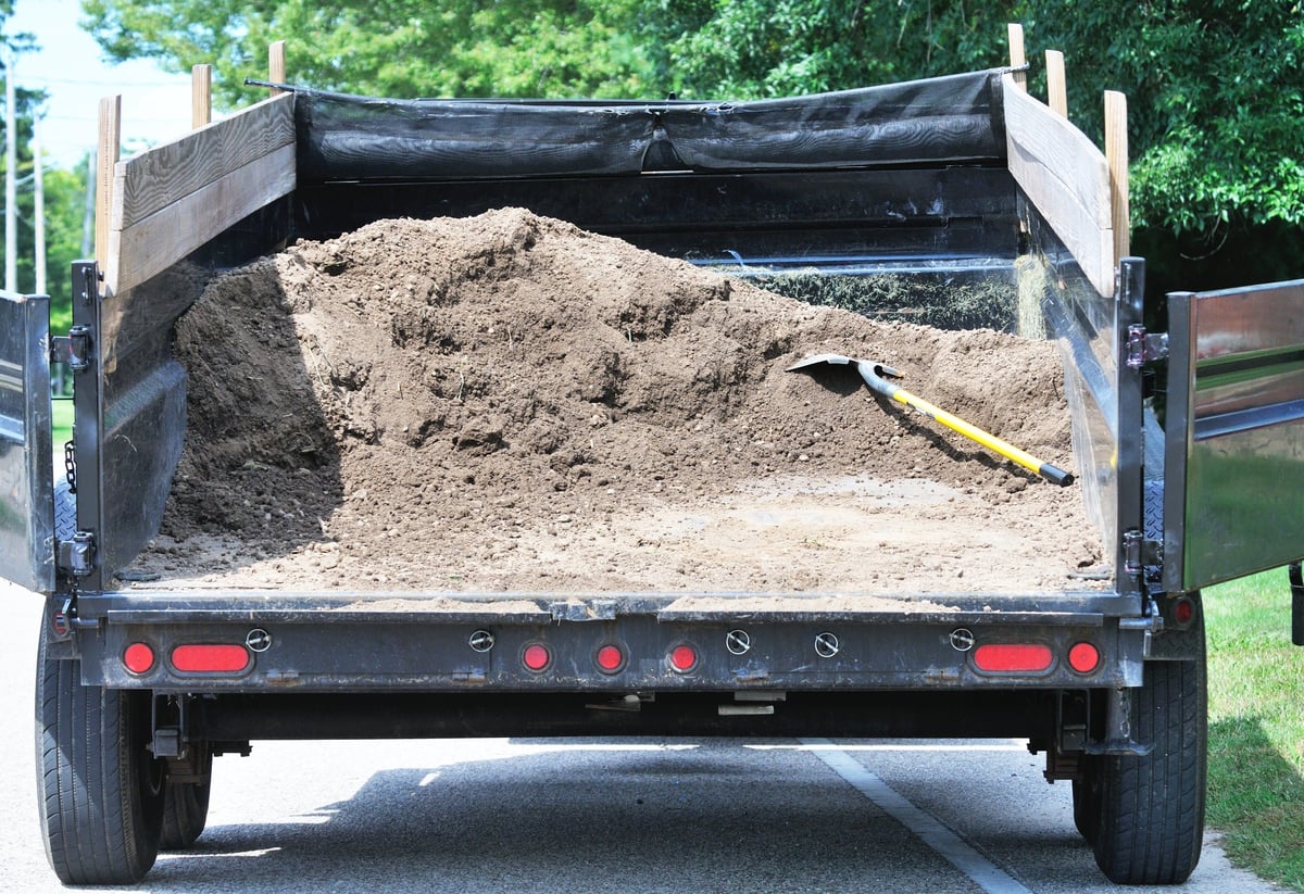 Load of dirt with shovel in dump wagon or trailer